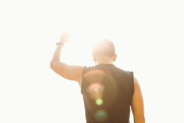 Winner .Successful happy accomplished athletic man stands with raised arms facing the sun.Male athlete with arms up celebrating and happy with his achievement and exercise.Success concept