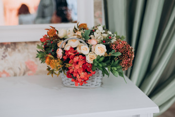 basket with flowers on a white table