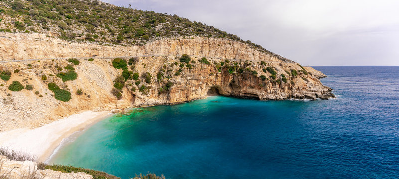 Amazing turquoise beach and cove on the way to Demre - Finike. Detail of cave. Kas, Antalya, Turkey. Summer and holiday background.