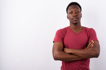Young handsome African man against white background