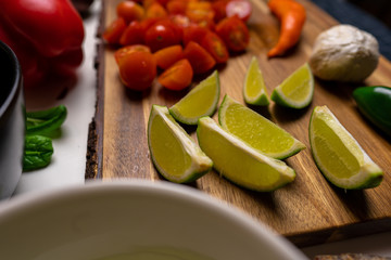 Close up of a cutting board with  a selection of healthy vegetables and fruit on a wooden cutting board