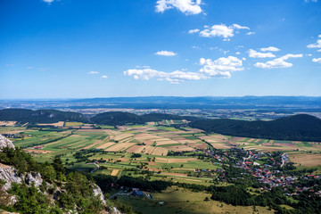 Fototapeta na wymiar Panoramic view of Hohe wand in Austria. Beautiful blue sky, clouds, rocks and plain.