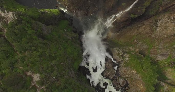 Flying over waterfall into epic canyon