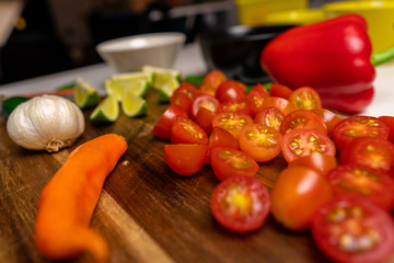 Close up of a cutting board with  a selection of healthy vegetables and fruit on a wooden cutting board