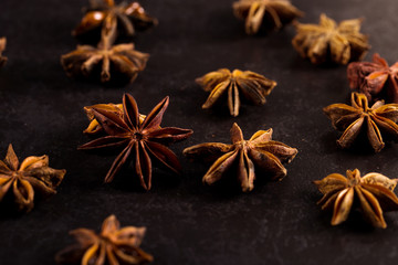 Star anise on black table. Concept, copy space.