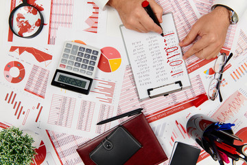 Fototapeta na wymiar Flat top view of businessman working and calculating finance, reads and writes reports. Business financial accounting concept.