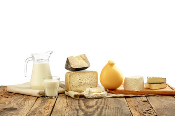 Different milk products, cheese, cream, milk on wooden table and white background. Healthy eating and lifestyle, organic natural nutrition, diet. Delicious food and drinks.