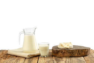 Different milk products, cheese, cream, milk on wooden table and white background. Healthy eating and lifestyle, organic natural nutrition, diet. Delicious food and drinks.