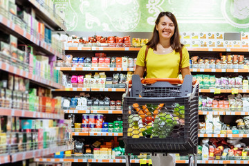 woman with shopping between store shelf portrait