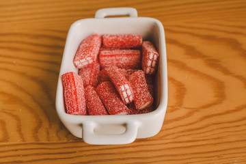 Close up of sugary candies as background and texture. Jelly sweets in a bowl. Red sugary candy ready to eat.