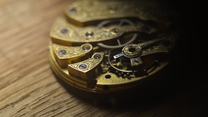  Close up inside mechanical vintage watch. Handmade engraving. Concept eternity, teamwork. Soft...