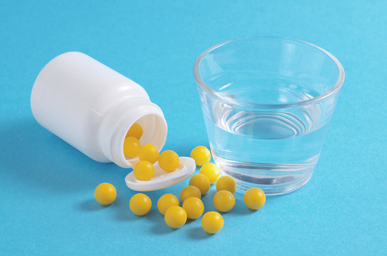 Yellow Vitamin Pills And Water
