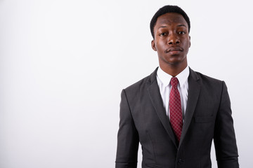 Young handsome African businessman wearing suit against white ba