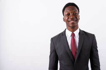 Young handsome African businessman wearing suit against white ba