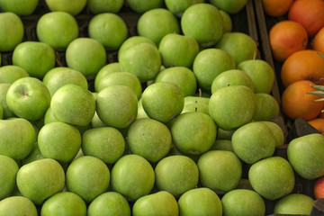 Front view of a Granny Smith Apples and  on a street grocery counter in old town. Grapefruit also...