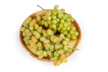 Sultana grape clusters on vintage wooden dish on white background
