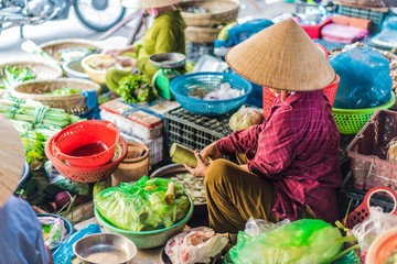 Women selling food on the street of Hoi An, Vietnam