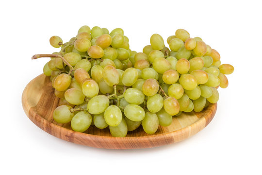 Sultana grape on vintage wooden dish on a white background