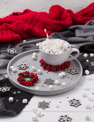 Christmas hot chocolate or coffee with marshmallow on white wooden table with christmas decorations