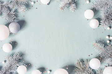 Light blue Christmas or New Year festive background with frosty fir branches - 298818002