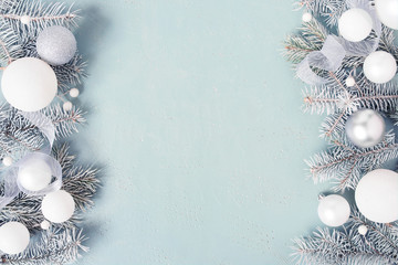 Light blue Christmas or New Year festive background with frosty fir branches