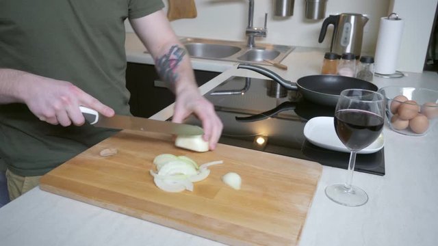Man cutting onion