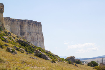 View of the white rock in a series of limestone mountains with flat peaks of white and gray in the Crimea on a Sunny day