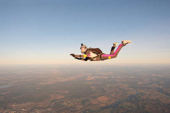 Skydiving. An active woman is flying in the sky.