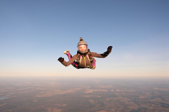 Skydiving. An active woman is flying in the sky.