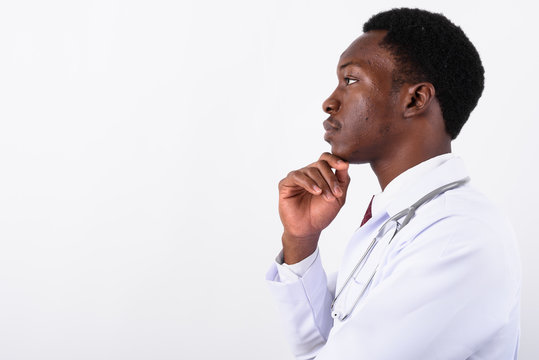 Young handsome African man doctor against white background