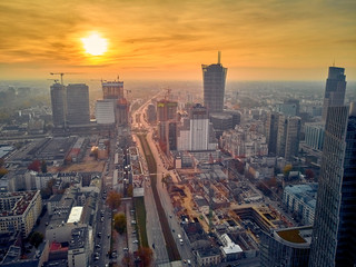 Beautiful panoramic aerial drone view to panorama cityscape of Warsaw modern City, Mennica Legacy Tower (140m) office skyscraper and Warsaw Spire, at sunset in autumn, Warsaw, Poland
