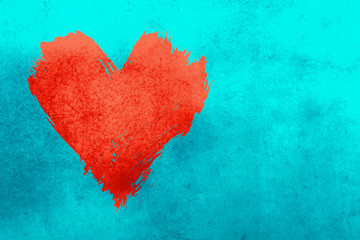 Red watercolor painted heart shape over blue