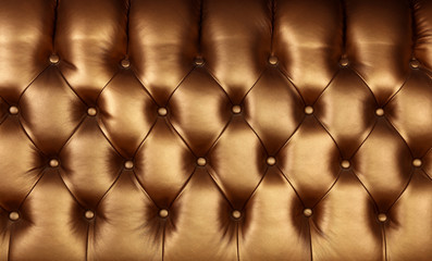 Golden brown leather capitone background texture
