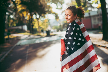 Athletic young woman with american flag. 