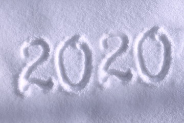 Abstract Christmas photo for beautiful Christmas card with background inscription 2020 on real white snow in winter in cold weather