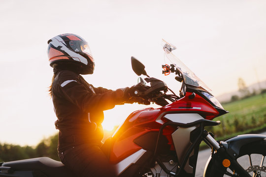 Woman riding motobike at sunset