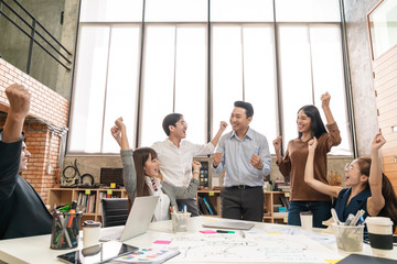 Happy asian creative team or staff employee feeling enjoy and looking together in meeting room at...