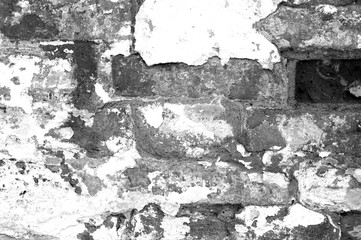 Old grungy brick wall texture in black and white.