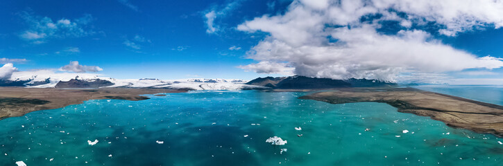 Iceland, panorama of Jokulsarlon lagoon. Picturesque blue landscape of Icelandic glacier lagoon. Icelandic famous landmark during summer season.