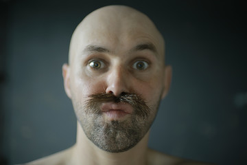 unusual portrait of a bald mustachioed young gentleman, eccentric mister, psychology concept