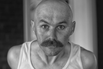 unusual portrait of a bald mustachioed young gentleman, eccentric mister, psychology concept