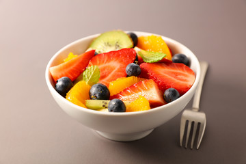 bowl of fruit salad and fork, studio shot
