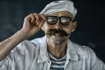 brutal cook with mustache, unusual marine chef in a vest, vintage style