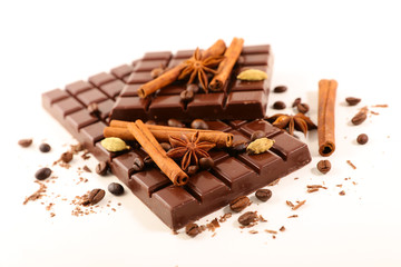 chocolate bar with spices on white background