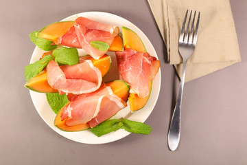 melon and prosciutto ham and basil ,top view