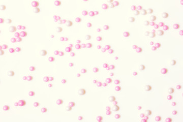 Vintage background with sugar pearls colored white and pink