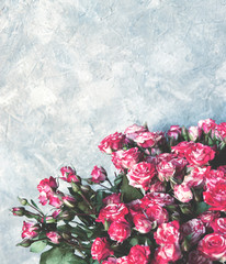 Bouquet of pink roses on grey textured background. Top view, copy space. Flat lay of Wedding, Women Day, Valentines Day, Mothers Day, birthday celebration concept. selective focus.  