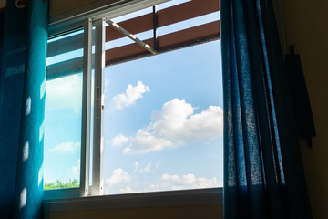 Fototapeta na wymiar Cloudy blue sky outside the window