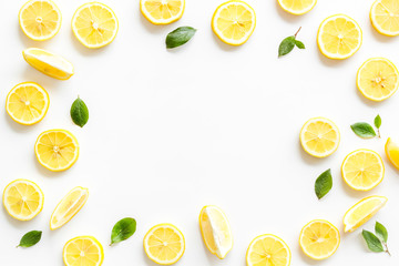 Fruit frame. Lemons and leaves on white background top view copy space