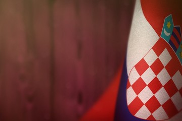 Croatia flag for honour of veterans day or memorial day. Glory to the Croatia heroes of war concept on pink blurred natural wood wall background.